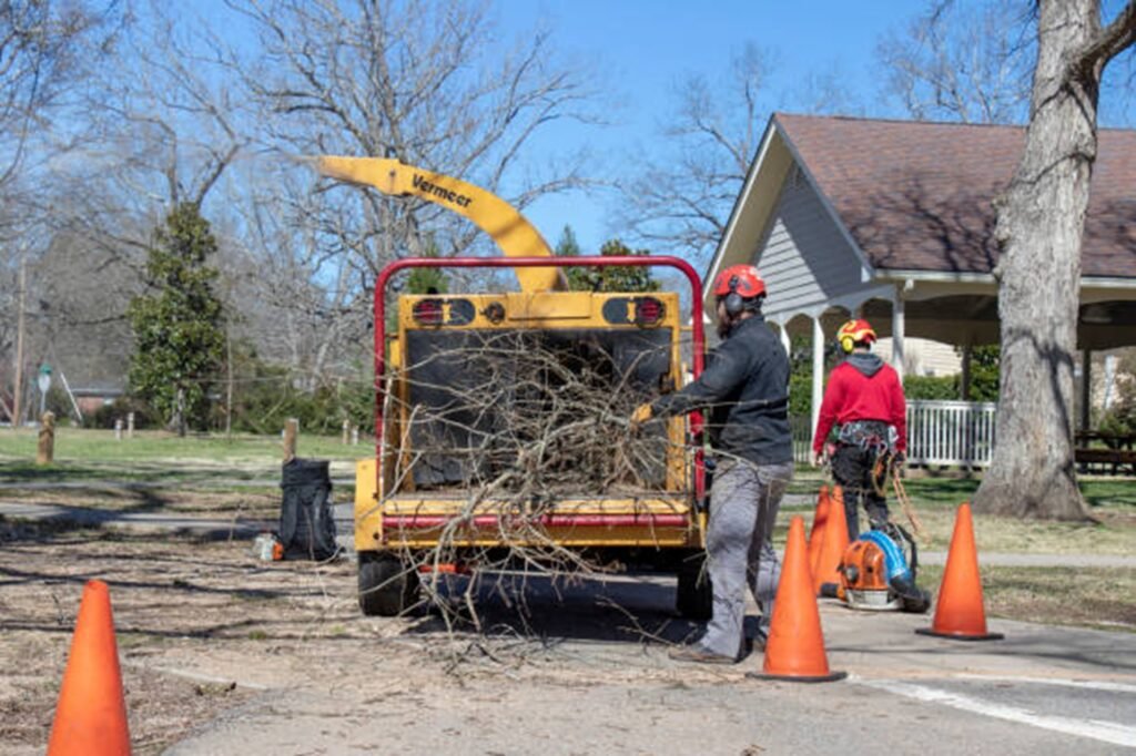 Wildwood Tree Service crew loading tree branches into a wood chipper after completing a residential tree service project in Wildwood, MO.