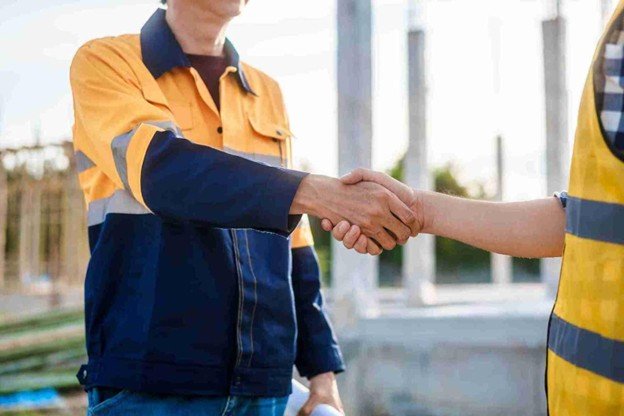 Ballwin Tree Service representative shaking hands with a satisfied homeowner after completing professional emergency tree service in Ballwin, MO.